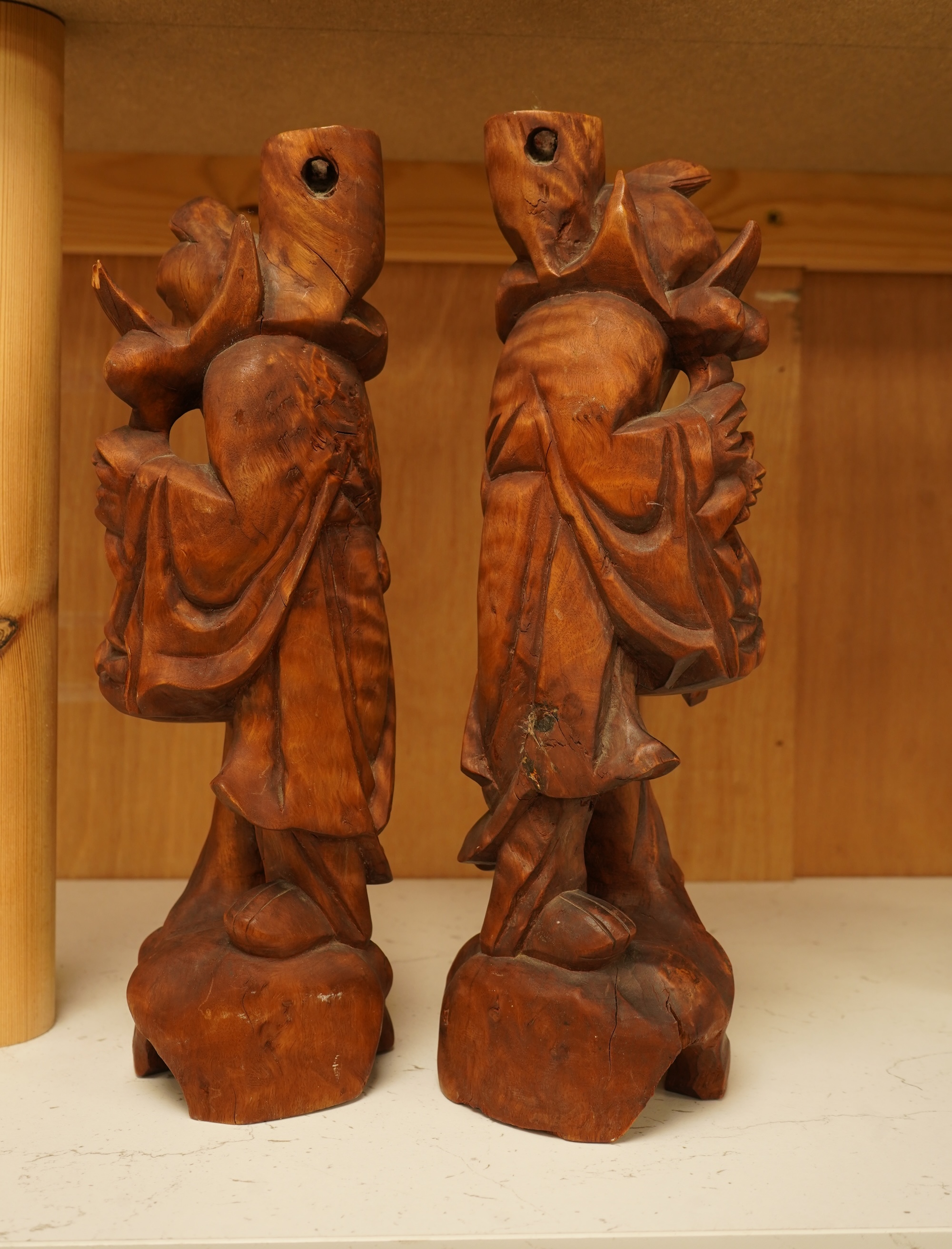 A pair of 20th century Chinese carved wood figures of sages, 31cm
